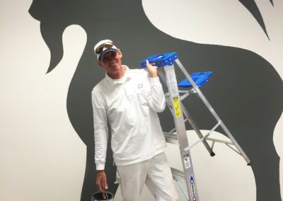 a painter is standing in front of the custom designed painting