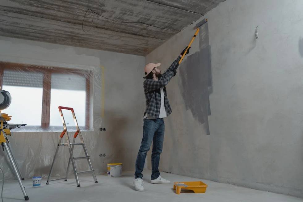 a painter is painting the walls of the house