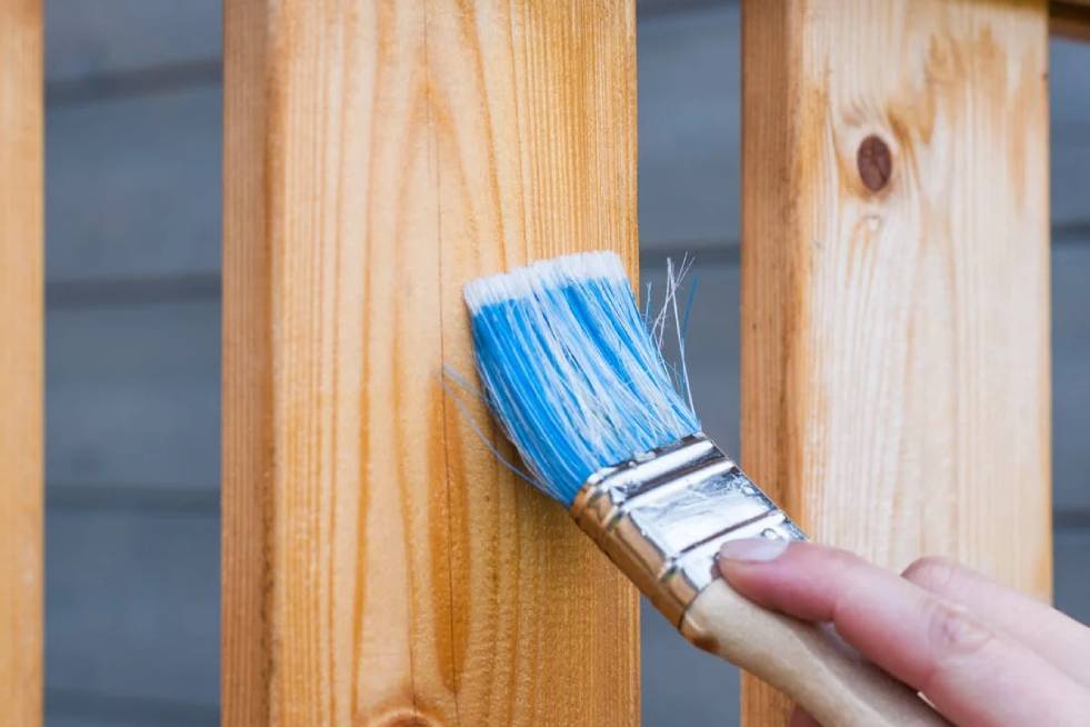 a painter is painting the furniture